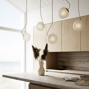 Bright Barocco lamps in a travertine beach house kitchen